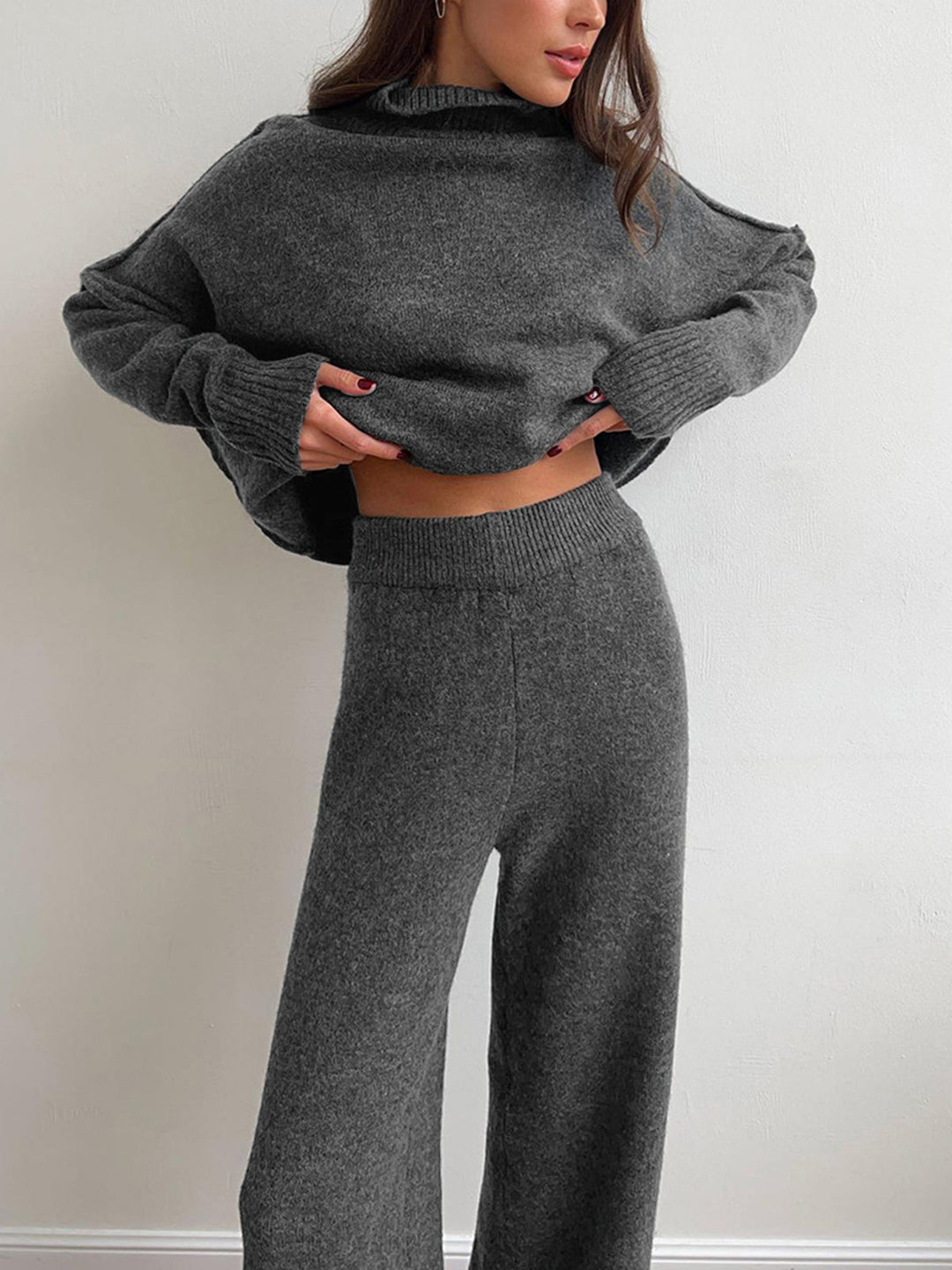 Full view of the women's red knitwear set: turtleneck top and matching pants