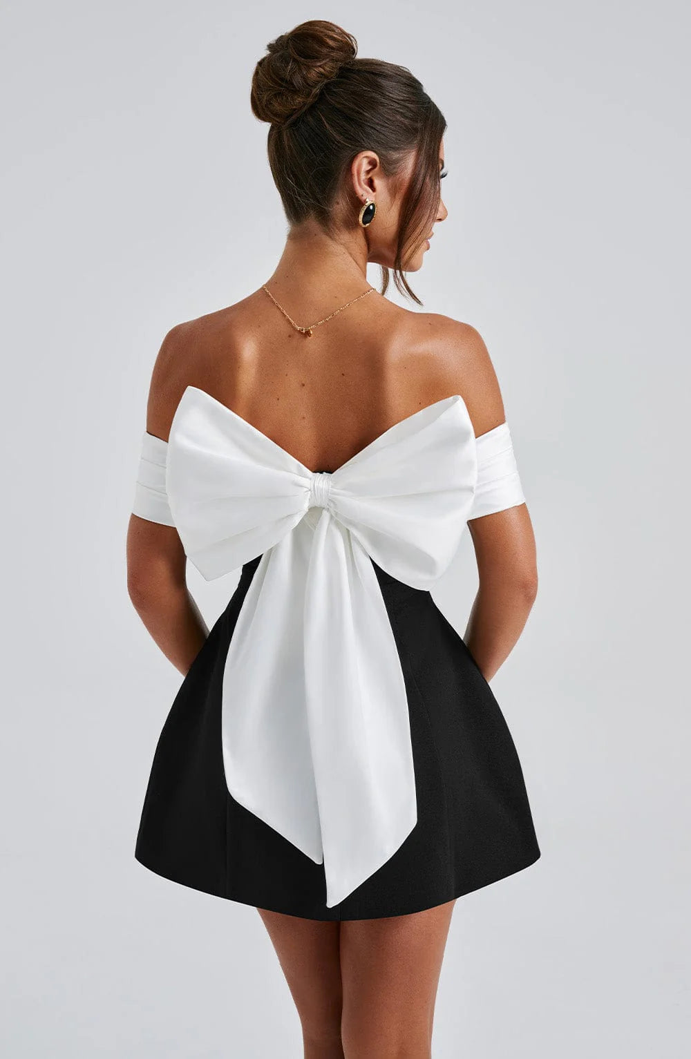 Chic black mini dress with elegant bardot neckline for parties