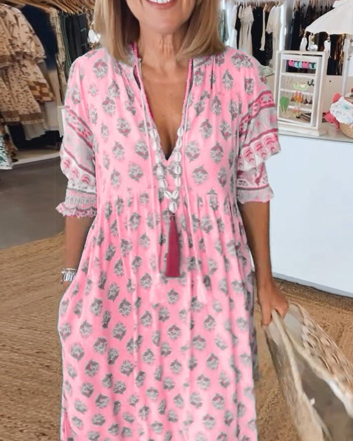 Flowy and feminine green floral midi dress with a deep v-neck.