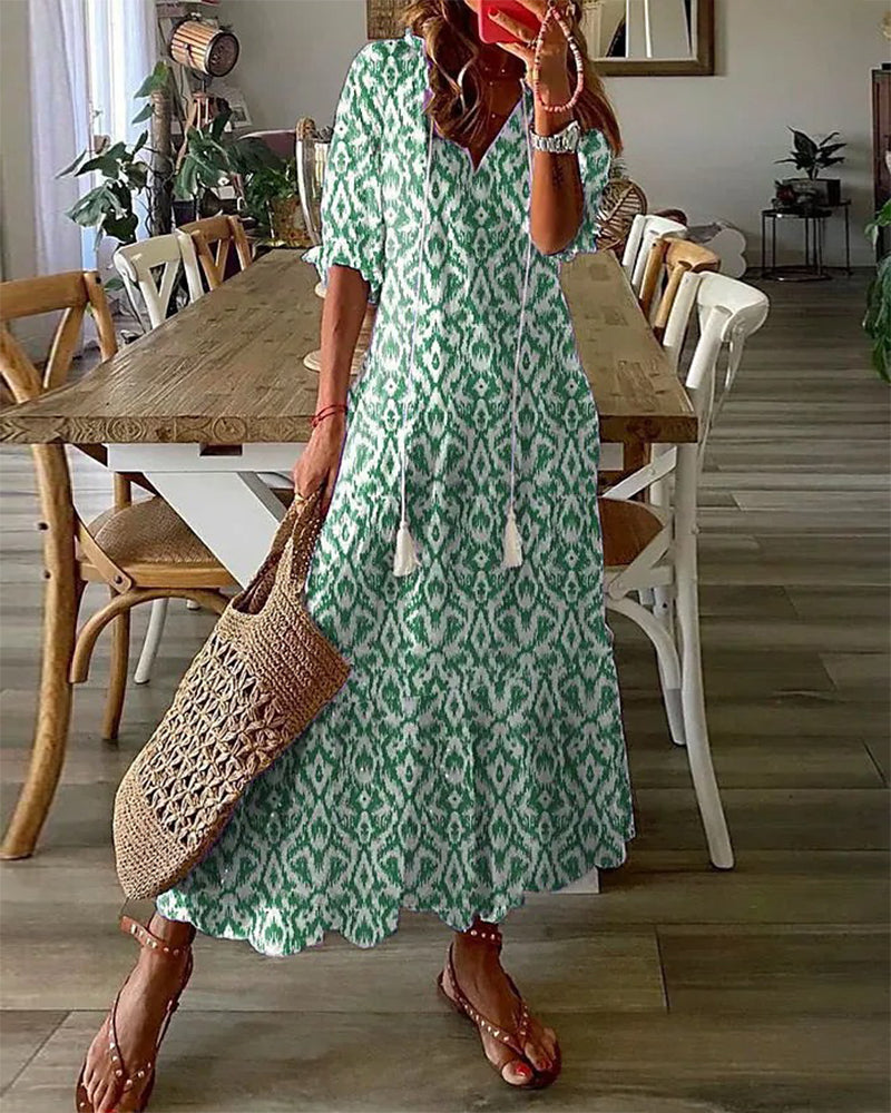 Bohemian style flowing V-neck dress with unique vintage print, ideal for women's fashion.
