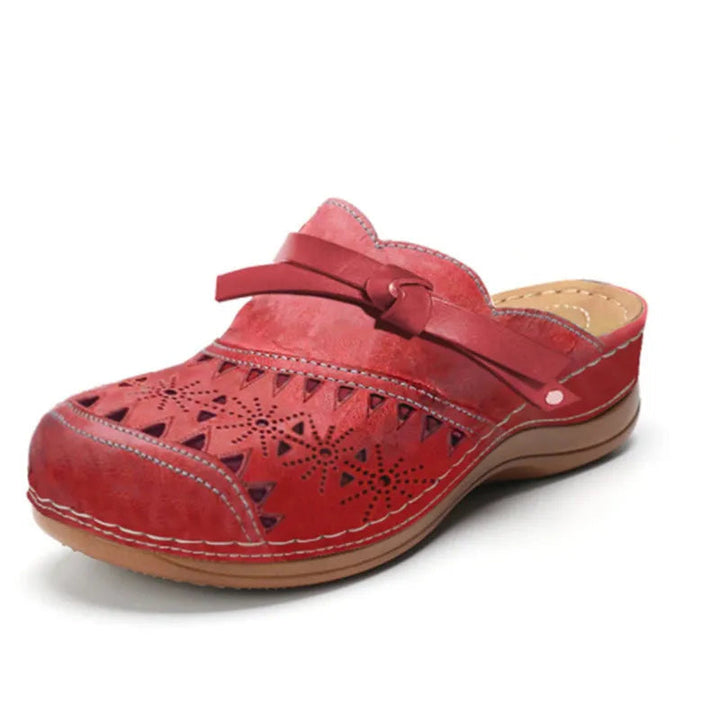 Casual backless women's clogs featuring a cute bow and cutouts. Easy slip-on shoes for summer style.