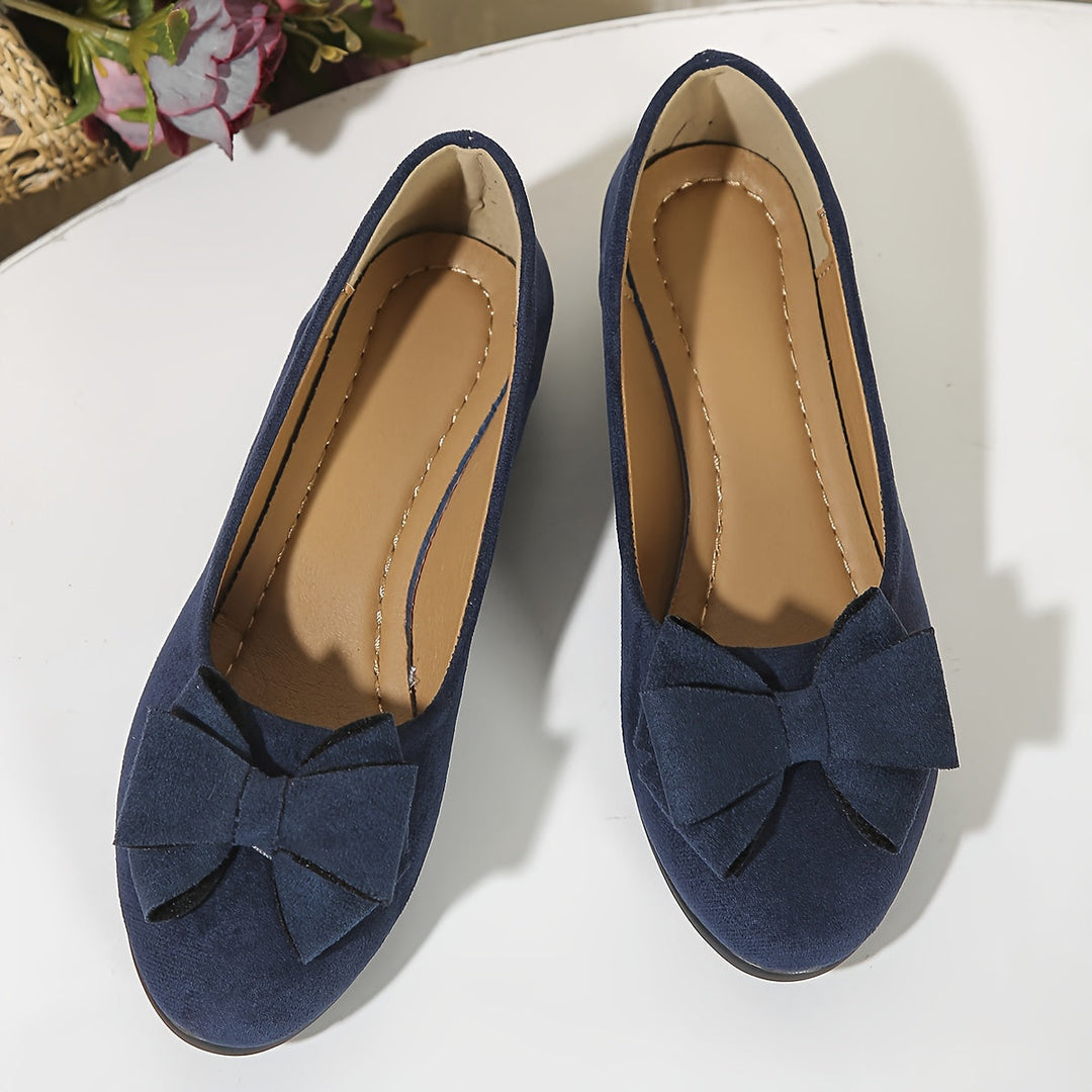Stylish slip-on women's wedge ballet flats with a bow, great for elegant casual wear.