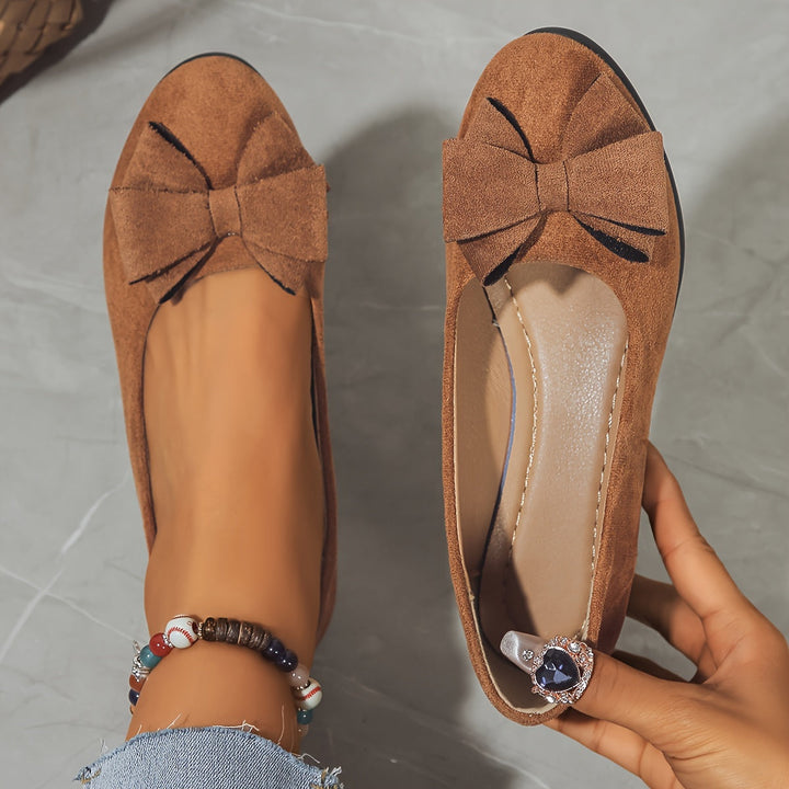 Chic women's slip-on wedge ballet flats with bow, ideal for sophisticated casual style.