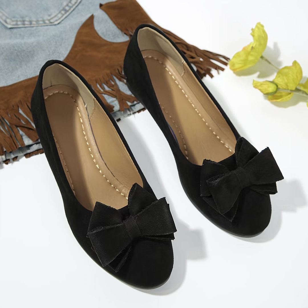 Women's casual slip-on wedge flats with a pretty bow, designed for comfort and style.