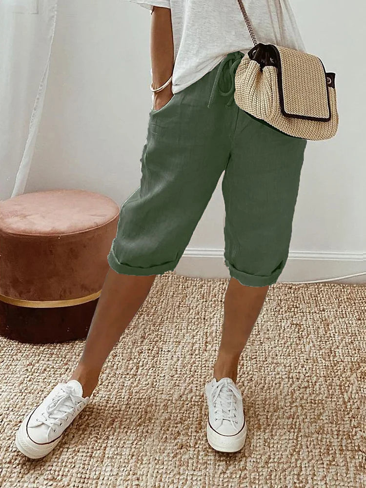 Beige women's comfortable knee-length pants, ideal for casual wear, featuring a breathable fabric & relaxed fit.