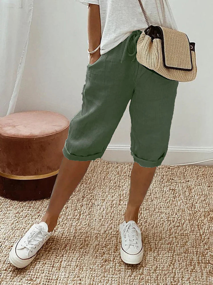 Beige women's comfortable knee-length pants, ideal for casual wear, featuring a breathable fabric & relaxed fit.
