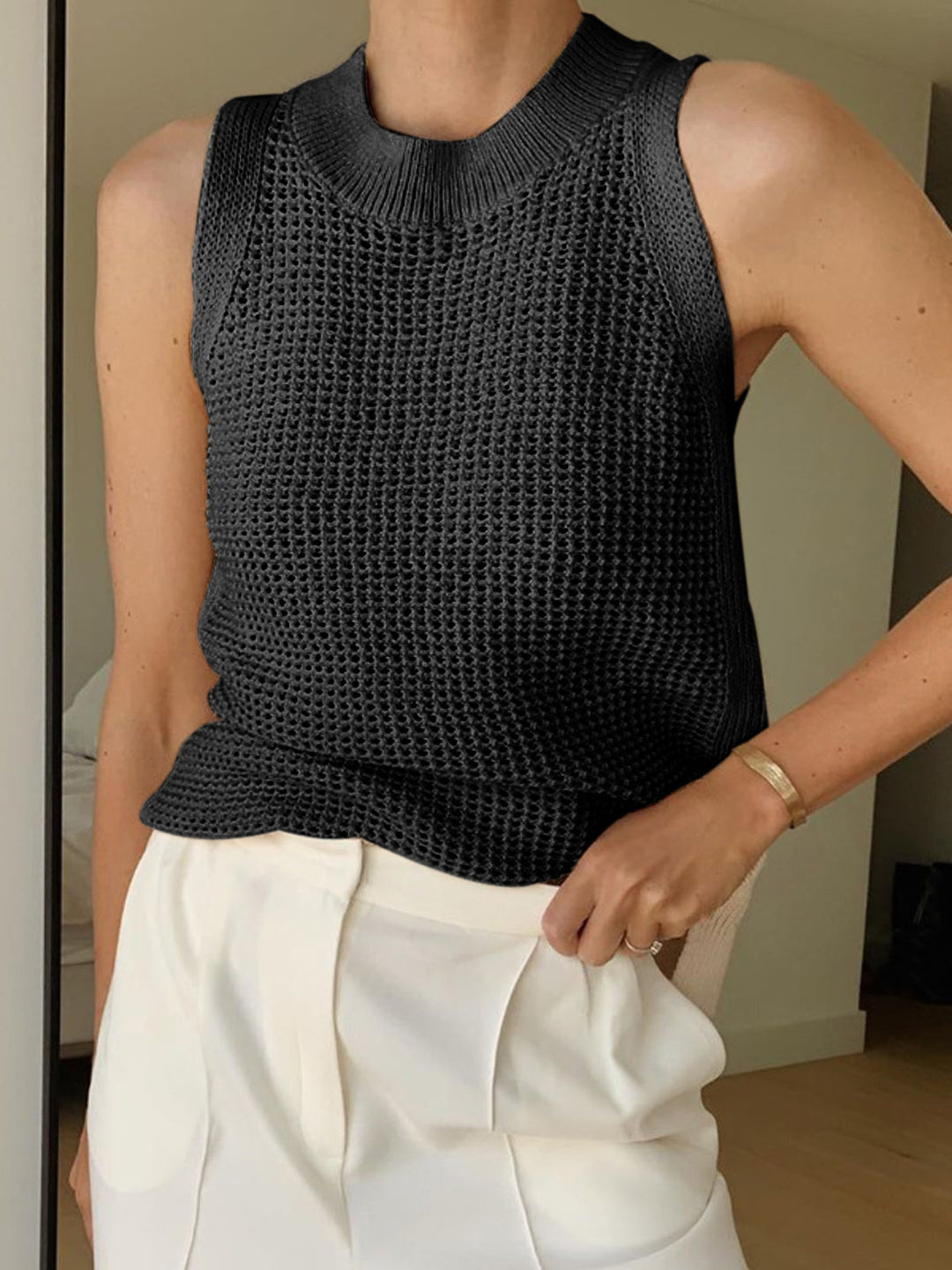 Chic women's hollow knit tank top, sleeveless and airy. Lightweight summer fashion for casual beachy style.