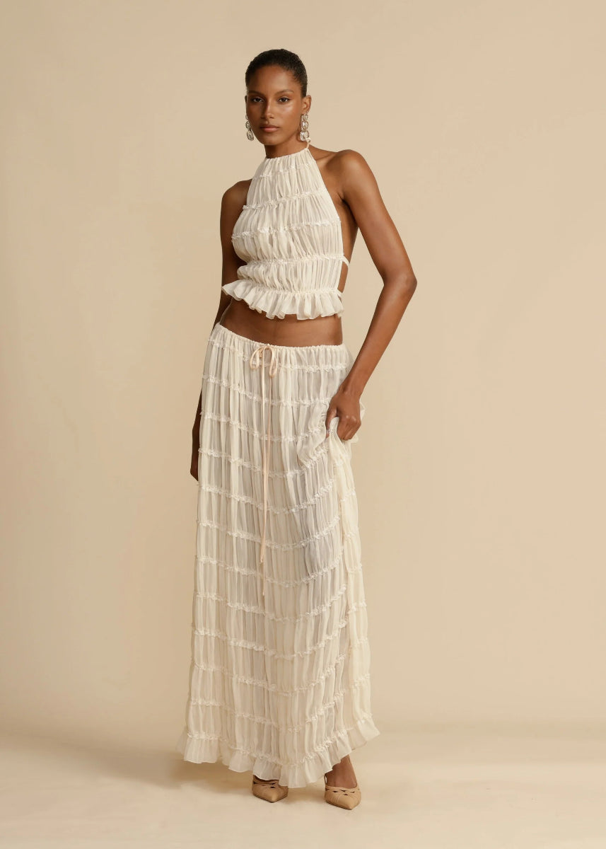 Black women's breezy two-piece summer set with a stylish halter top and long maxi skirt.