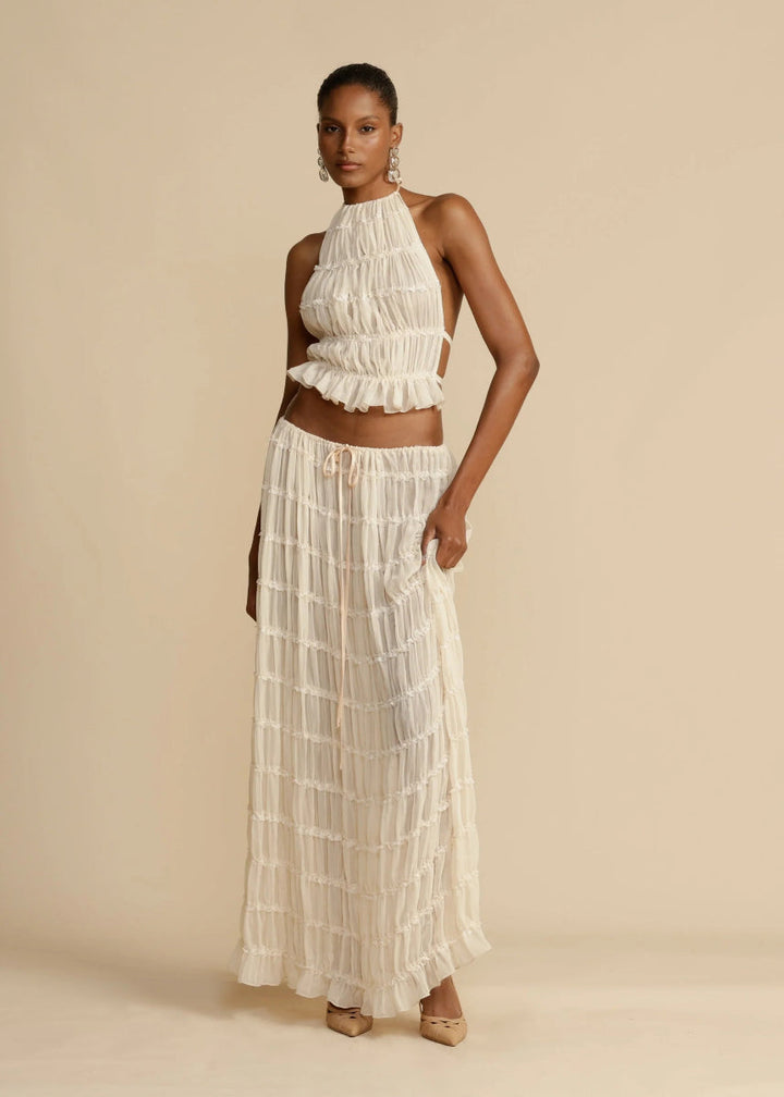 Black women's breezy two-piece summer set with a stylish halter top and long maxi skirt.