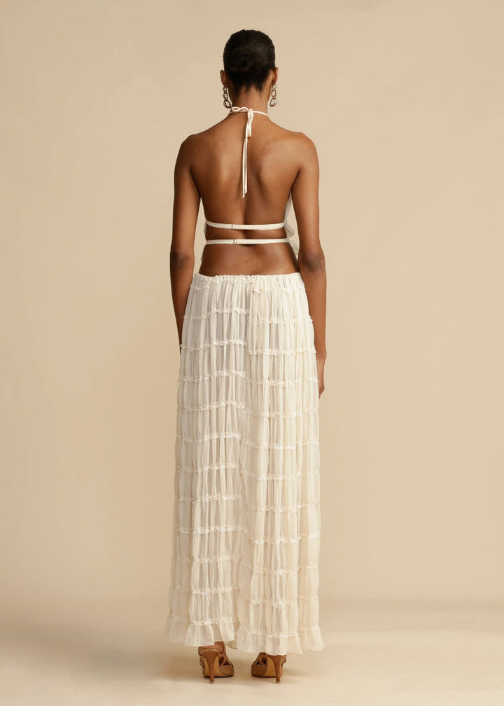 Chic women's two-piece summer set: elegant halter top and long, breezy maxi skirt for a stylish look.