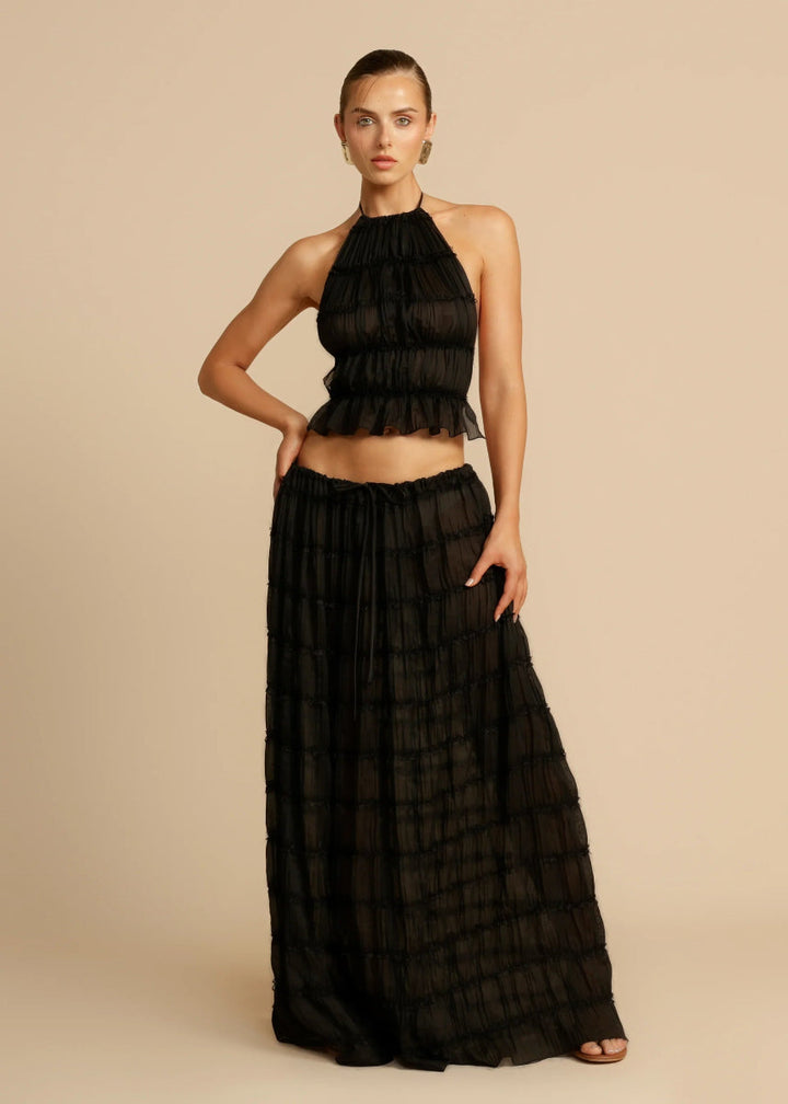Black comfortable women's two-piece summer set with a stylish halter top and flowy maxi skirt.