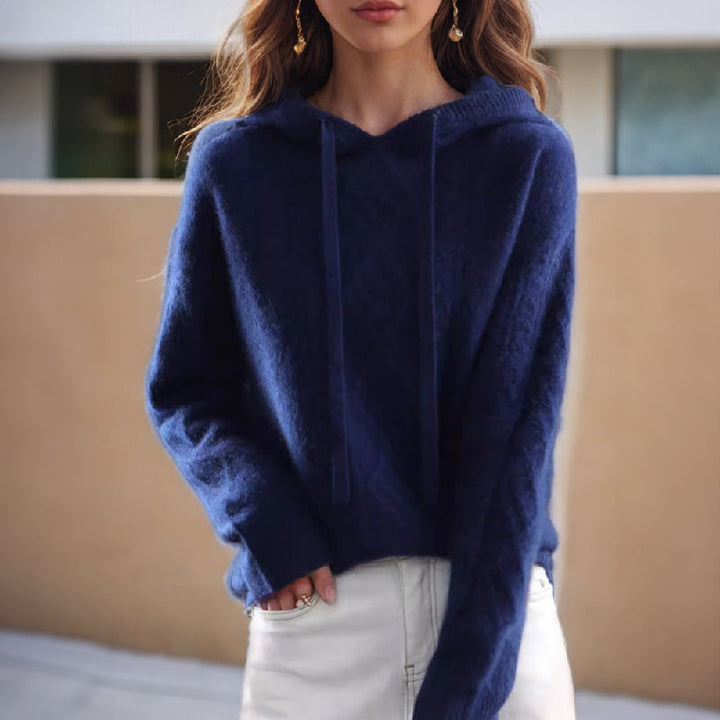 Women's comfortable hooded pullover with intricate cable knit pattern. A stylish relaxed fit top for casual wear.