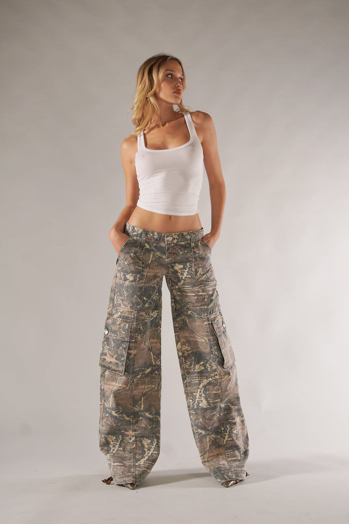 Fashionable women's cargo pants in a classic camo pattern, featuring practical pockets.