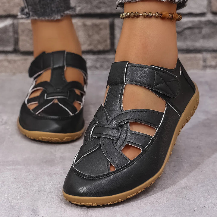 Stylish open-toe walking sandals for women, featuring breathable cutout design and velcro closure.