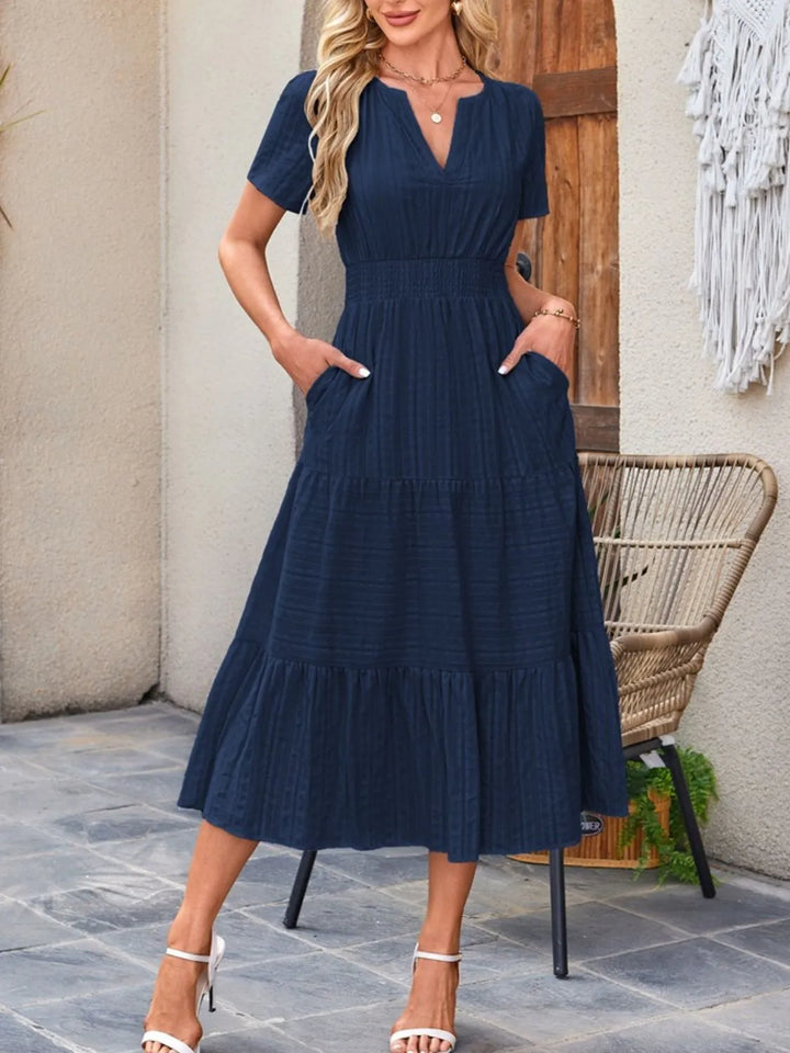 This casual midi dress showcases its flowy fabric and convenient pocket detail.