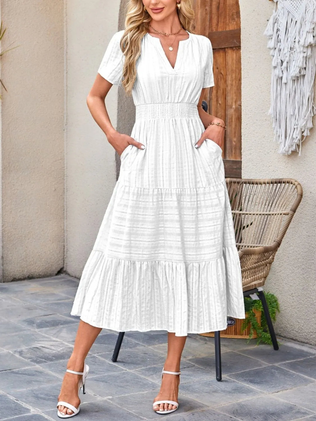 A woman wearing a casual midi dress with short sleeves and a flowing skirt.