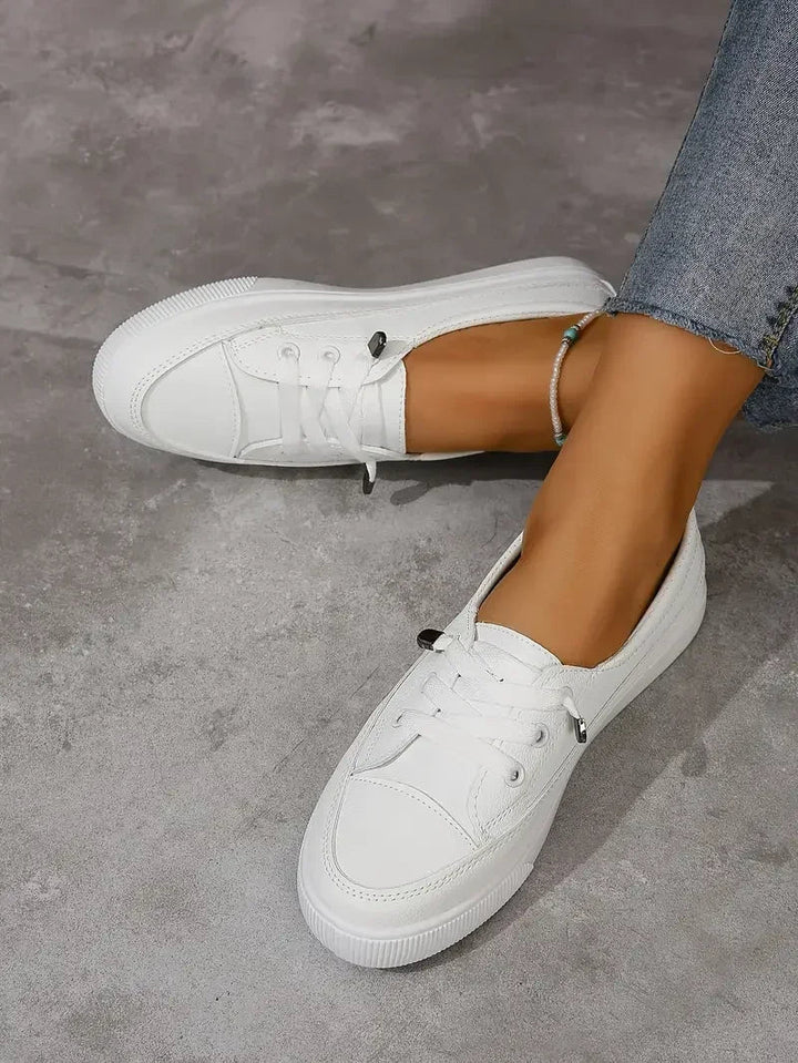 Women's casual lace-up flat sneakers for everyday comfort. Versatile white walking shoes for spring and summer.
