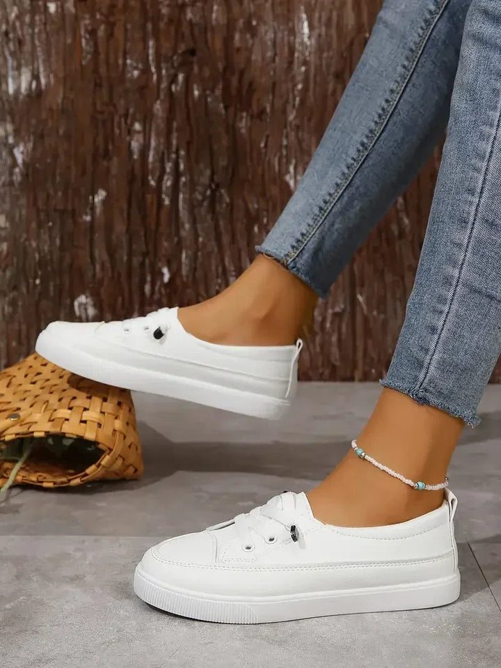Versatile white women's lace-up sneakers. Perfect casual flats for comfortable walking and everyday style.