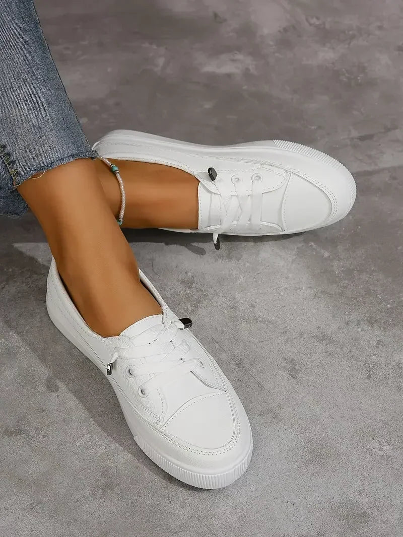 Spring/summer women's casual lace-up sneakers. White low-top flats for comfortable, versatile everyday shoes.