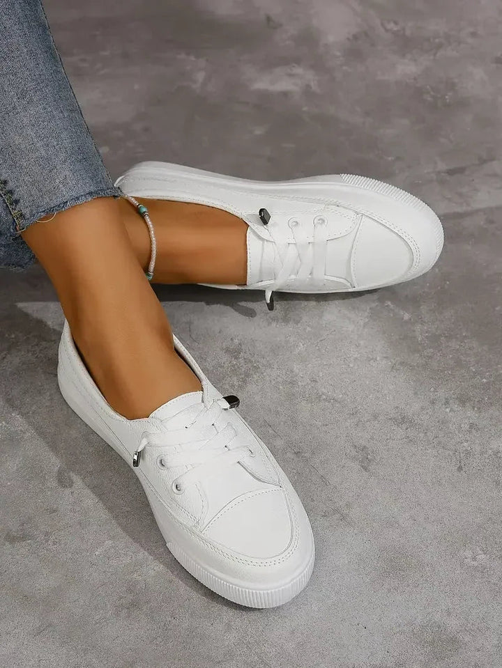 Spring/summer women's casual lace-up sneakers. White low-top flats for comfortable, versatile everyday shoes.