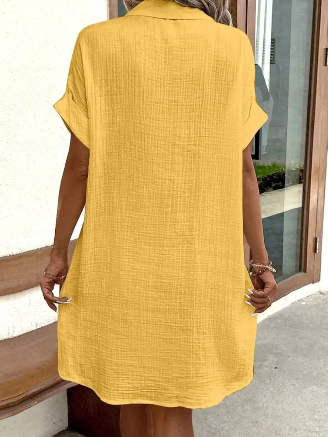 This women's button-down mini dress offers both style and practicality