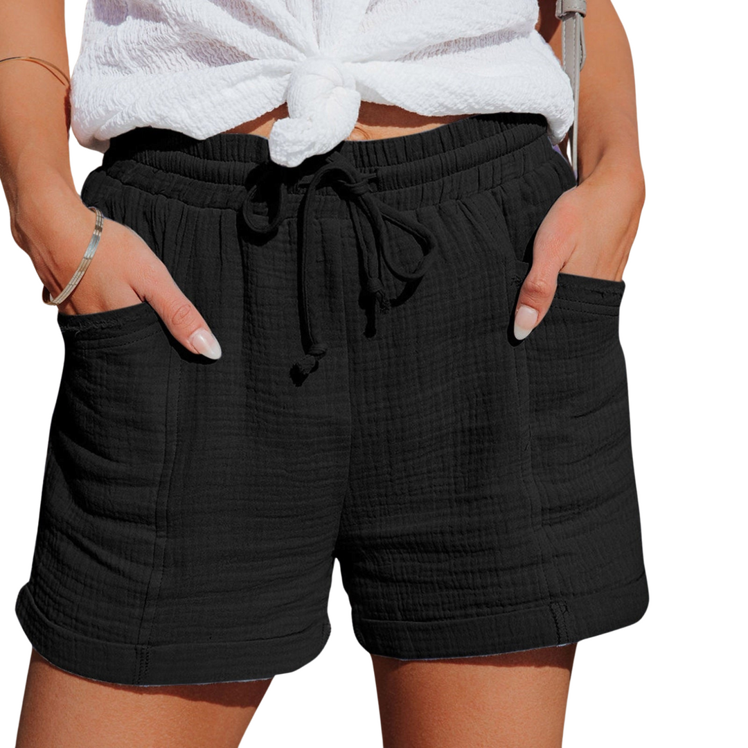 Comfortable women's summer shorts featuring a practical front pocket and drawstring closure.
