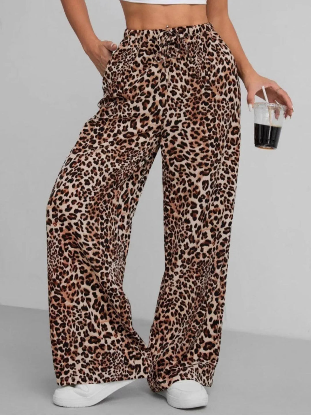 Close-up of soft fabric on women's leopard print wide leg pants, highlighting comfort.