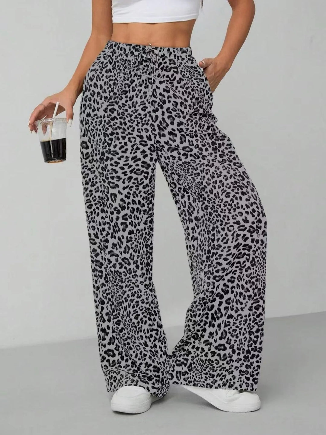 Model wearing fashionable women's leopard print wide leg pants, perfect for casual outings.