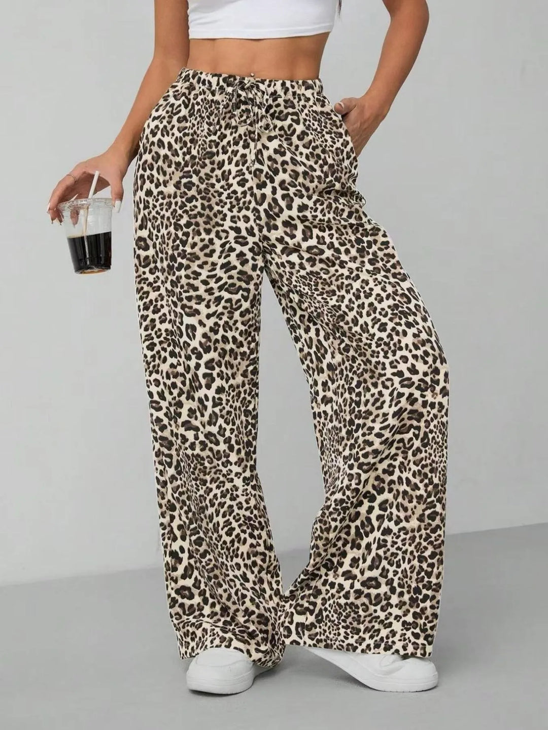 Full view of women's trendy leopard print wide leg pants, showcasing the bold pattern.
