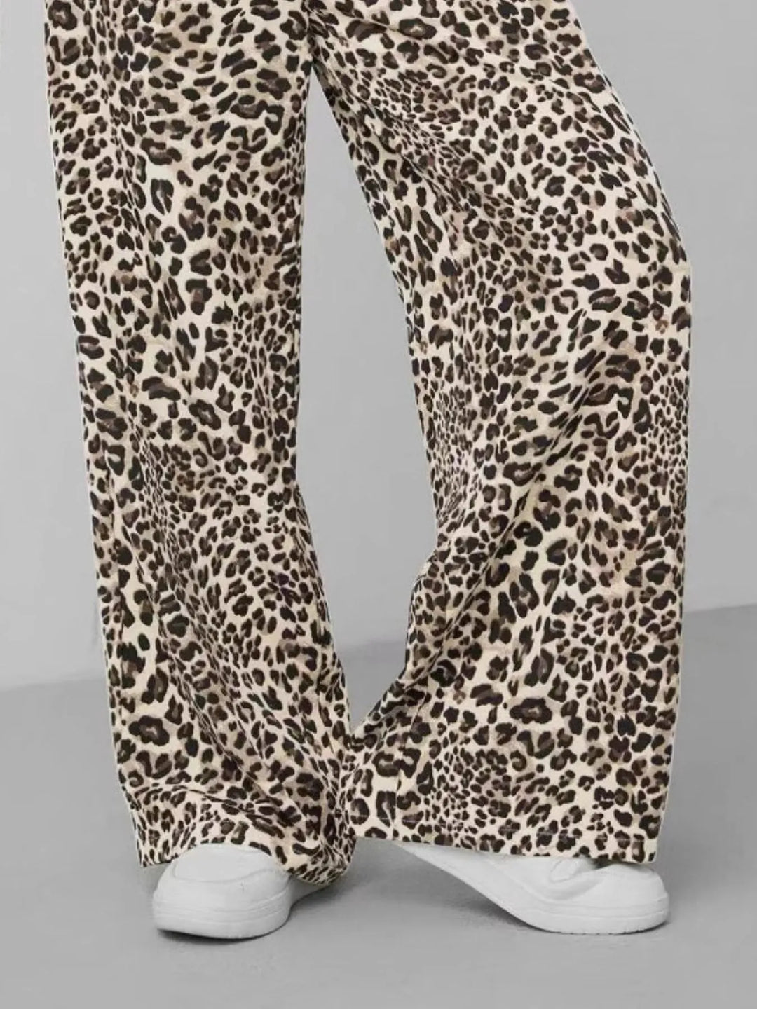 Detail shot of the drawstring closure on comfortable women's leopard print wide leg pants.