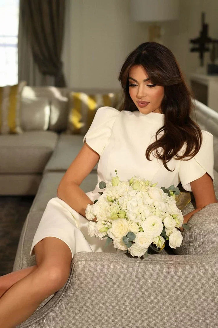 Chic cocktail mini dress with voluminous puffed sleeves, perfect for parties.