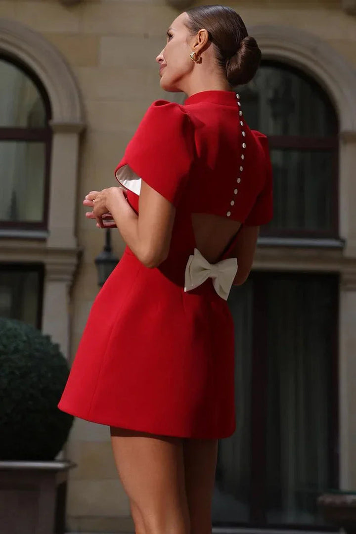 Showcase your feminine style in this chic mini dress with dramatic puffed sleeves.