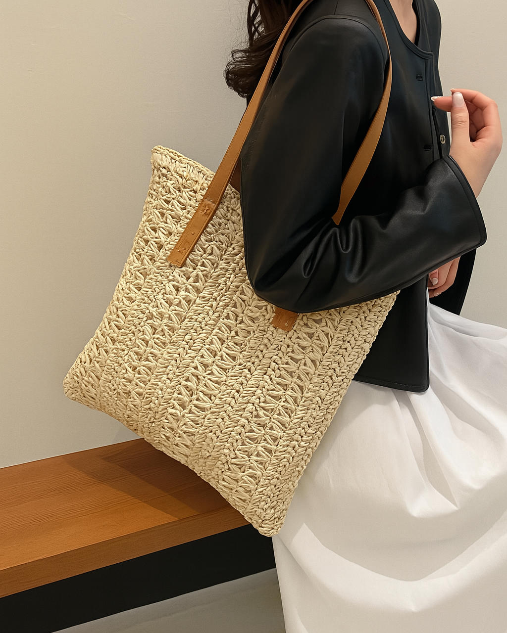 Stylish women's woven straw tote bag with shoulder strap. Casual summer accessory, natural texture & spacious design.