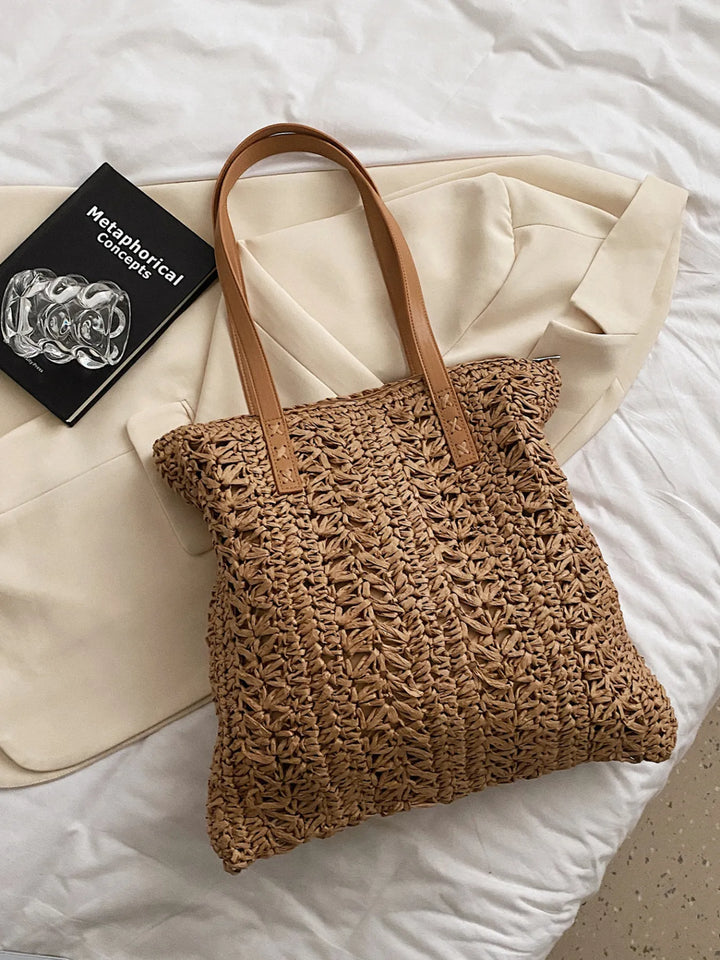 Elegant women's straw shoulder bag, ideal summer beach tote. Woven natural fibers offer a chic, lightweight accessory.