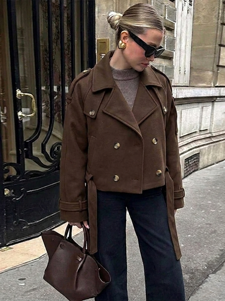 Women's classic chocolate brown cropped trench coat with double-breasted style and oversized lapels.