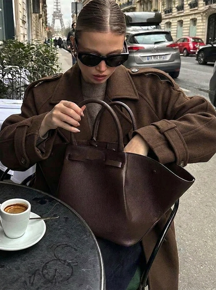 Double-breasted chocolate brown cropped trench coat for women, featuring oversized lapels and classic style.
