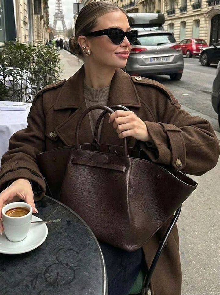 Classic women's cropped trench coat in chocolate brown. Double-breasted design, stylish outerwear for fall/winter.