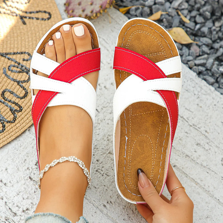 Women's classic cross-strap low heel sandals in tan leather.