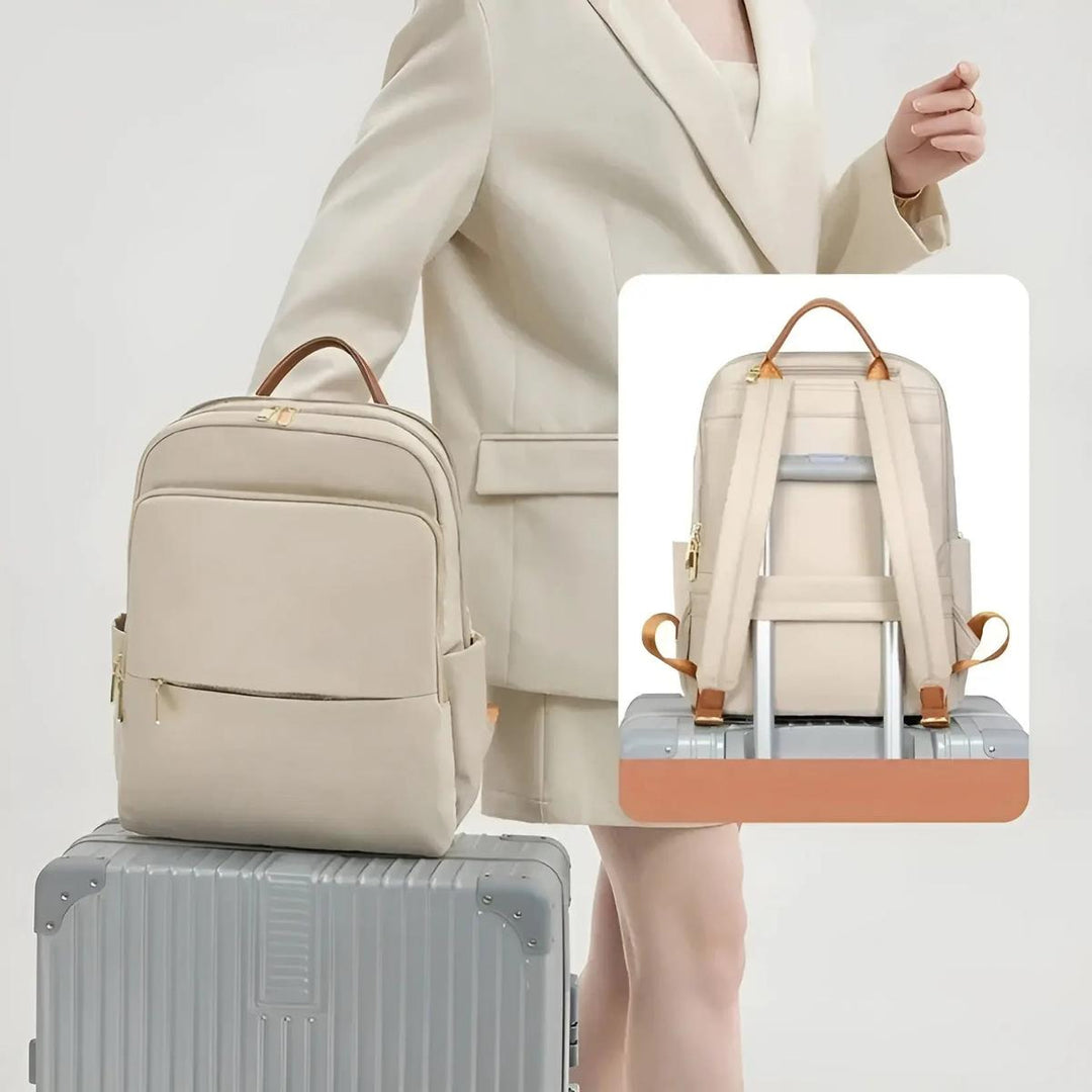 Minimalist black women's waterproof laptop backpack. Sleek design for commuters, work & travel.