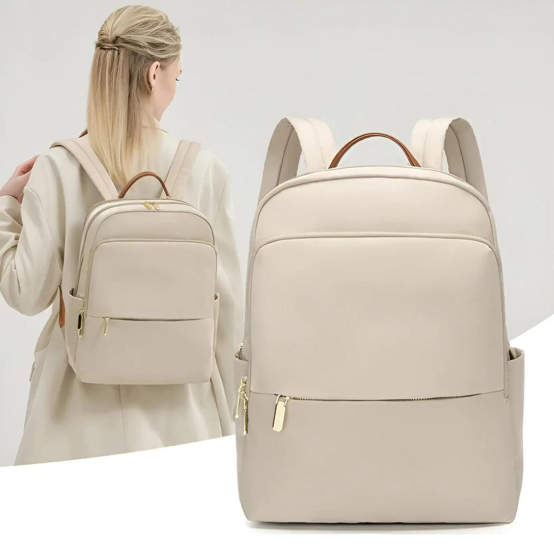 Modern grey women's clean waterproof laptop backpack. Essential for organized daily carry & tech safety.