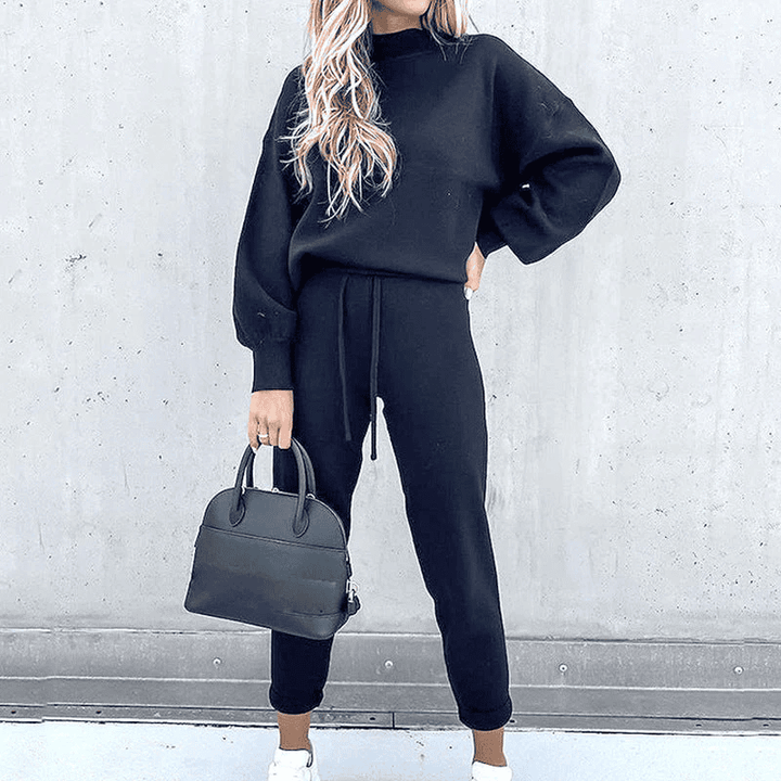 Women's two-piece casual loungewear outfit. Relaxed turtleneck top and comfortable high-waist pants for everyday.