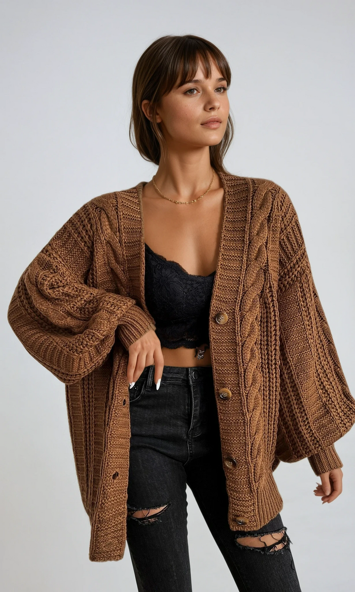 Women's cozy oversized cable knit cardigan in a warm tone, perfect for layering during fall.
