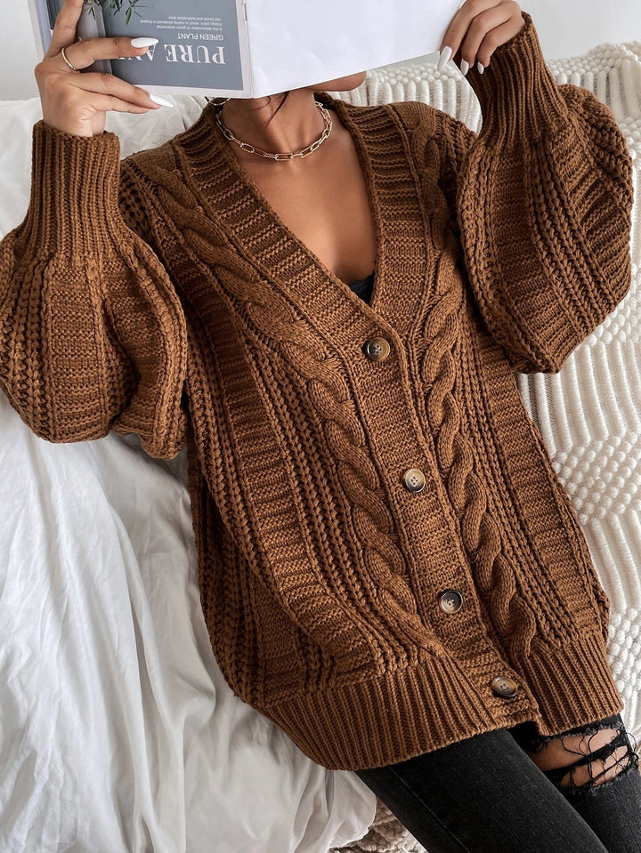 Comfortable women's cable knit cardigan, oversized design for cozy fall and winter layering.