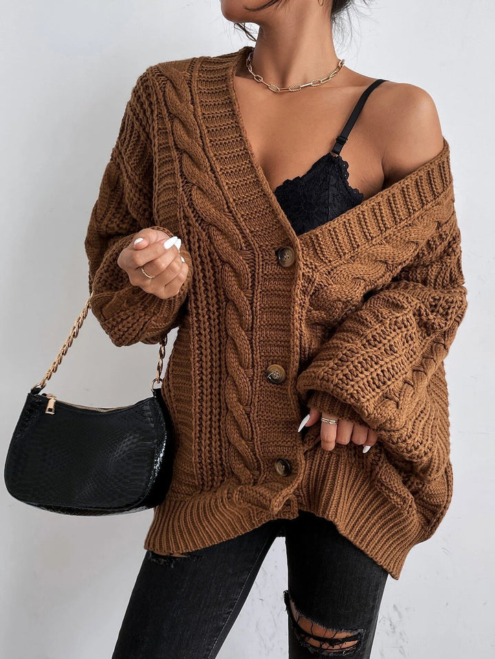 Chic women's oversized cable knit cardigan, a versatile knitwear piece for layering outfits.