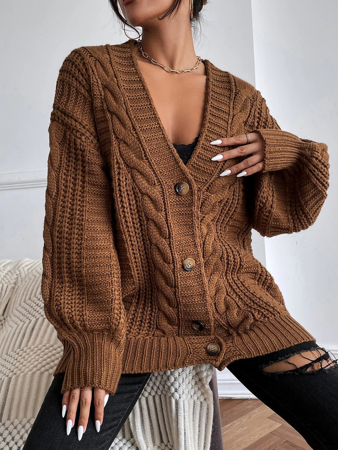 Soft women's oversized cable knit cardigan, perfect comfortwear for casual and stylish looks.