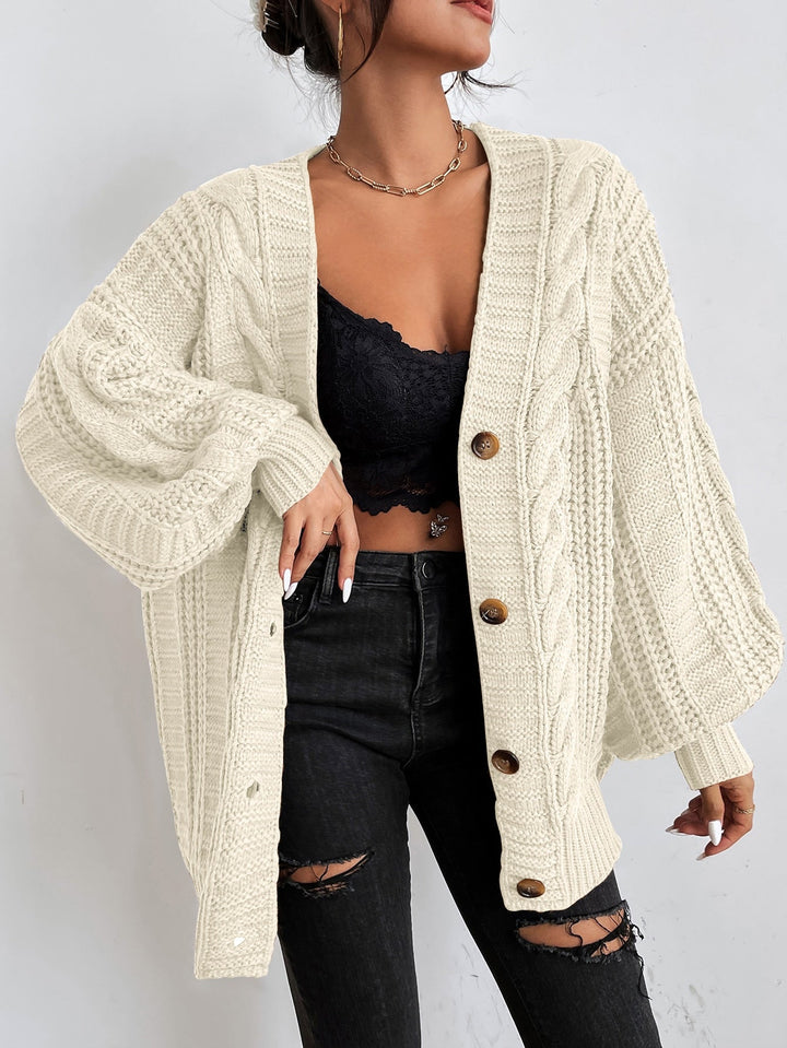 Elegant women's oversized cable knit cardigan, a timeless layering piece for fall fashion.