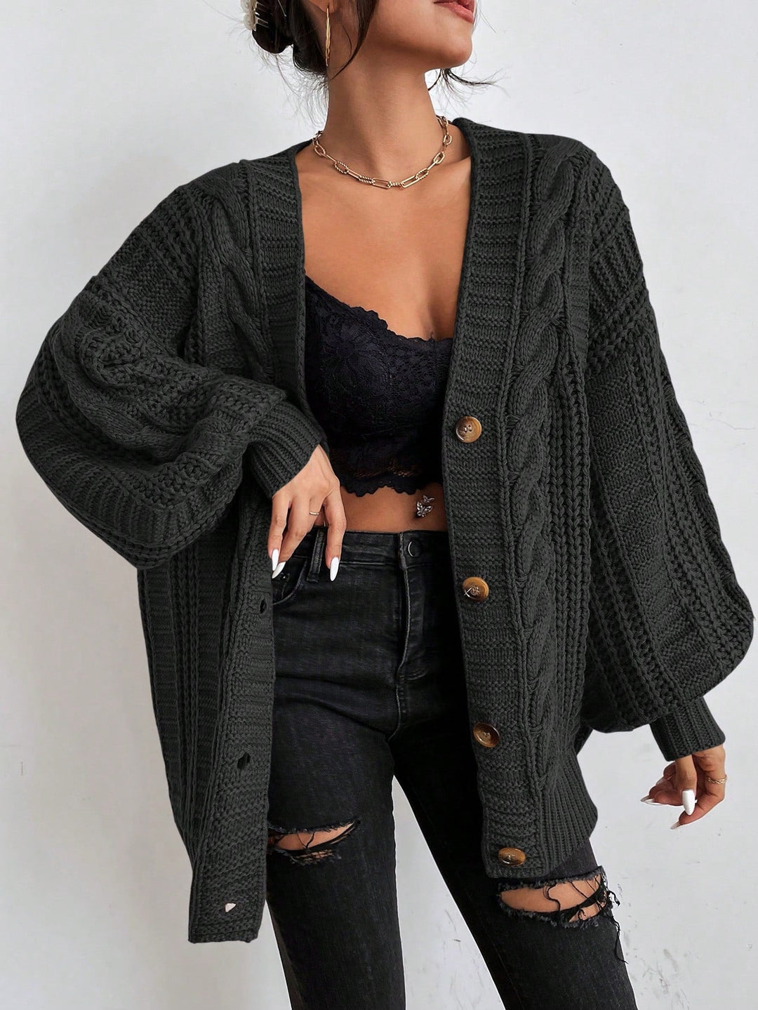 Women's heavy gauge cable knit cardigan, oversized and cozy for ultimate winter comfort.