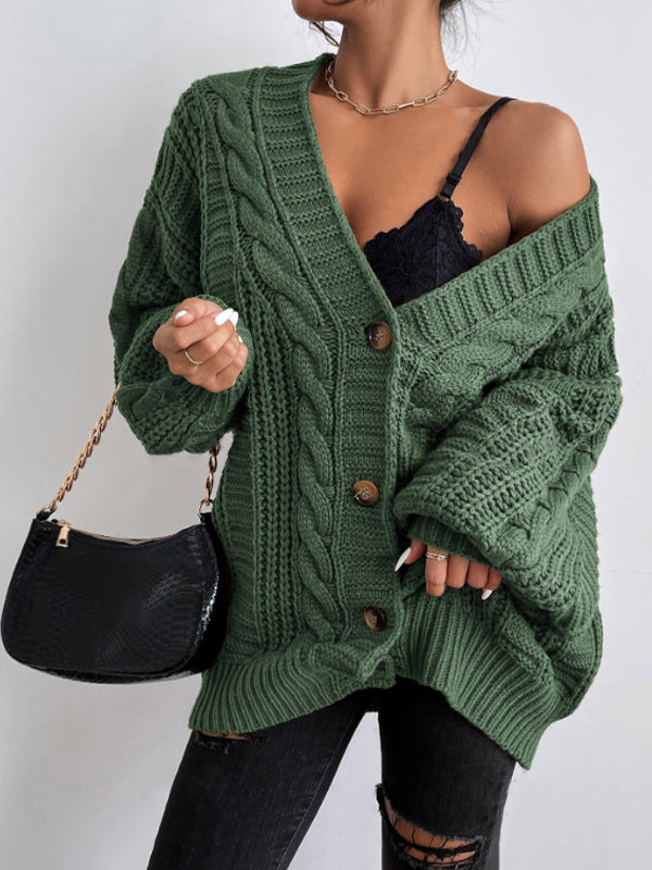 Fashionable women's oversized cable knit cardigan, ideal for layering in cold weather.