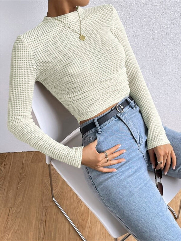 Stylish women's cropped waffle knit long sleeve top, perfect for casual autumn style.