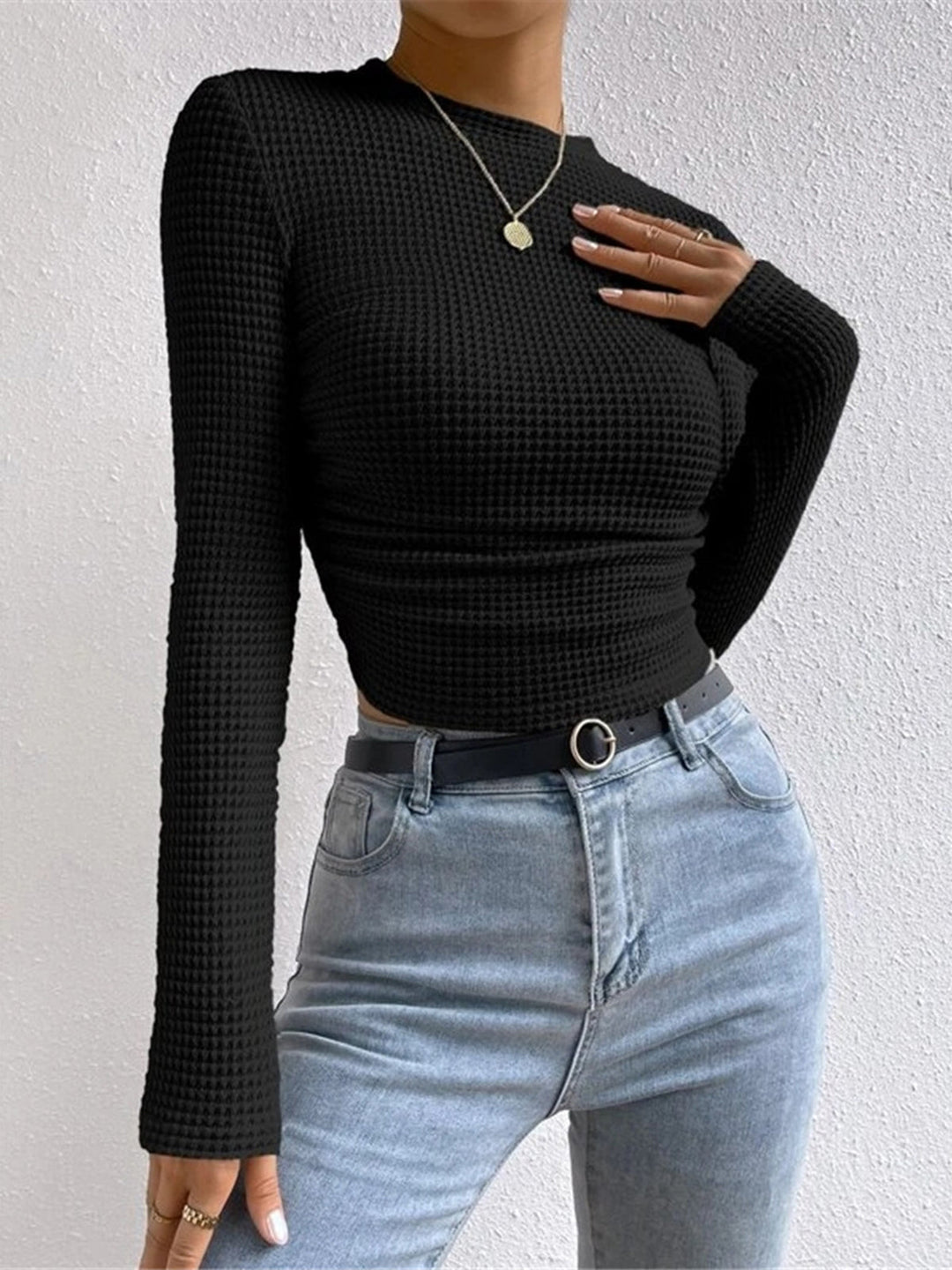 Trendy women's waffle knit long sleeve top, offering versatile fashion for casual comfort.